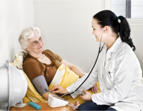 Nurse checking the blood pressure of a senior